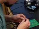 A student at Madison High School in Rexburg, Idaho, assembles a 5 Building Blocks Activity Board. See “Building Blocks Illustrate Basic Electronics” in the current edition of Radio Waves. [Ron Call, N7GOA, photo]